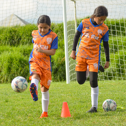 girls in soccer uniforms warming up for a game.